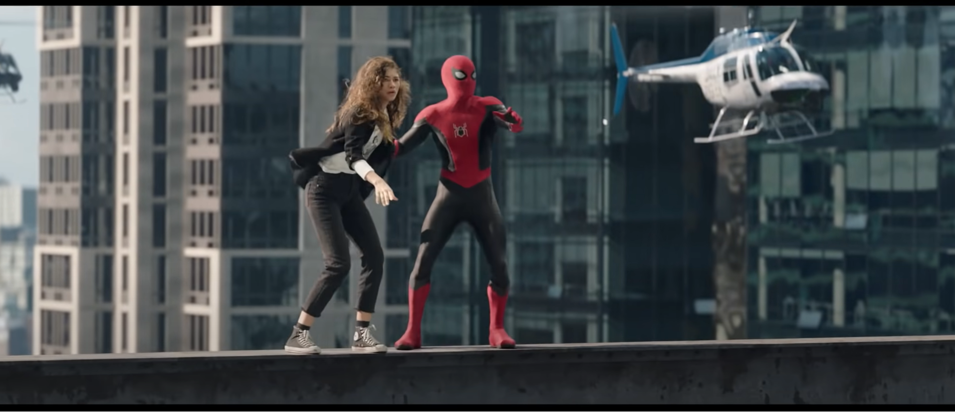 Spider-Man and MJ atop a bridge while running from authorities.