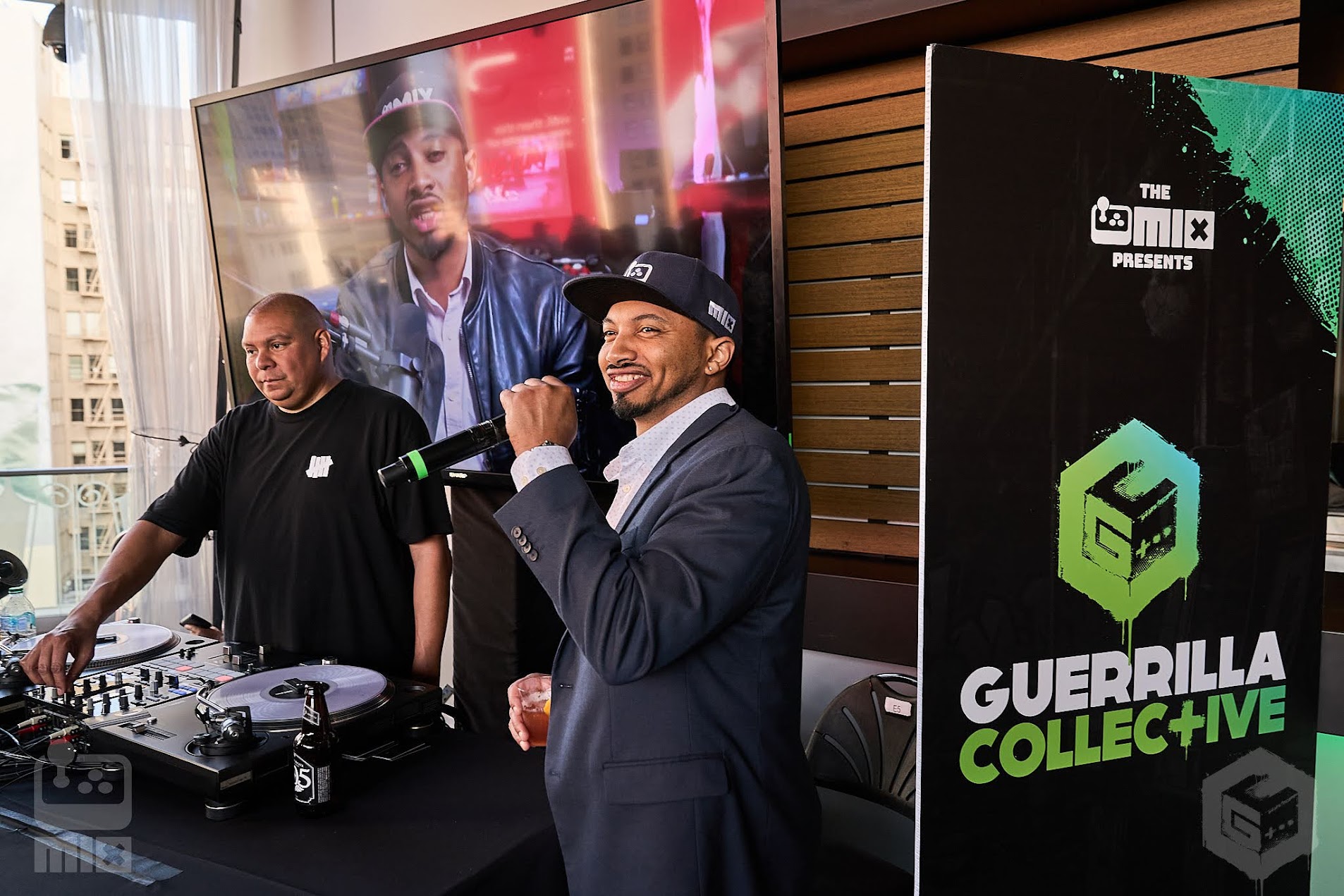 Justin Woodward (right), director and co-founder of interabang speaking into a mic at an indie game convention